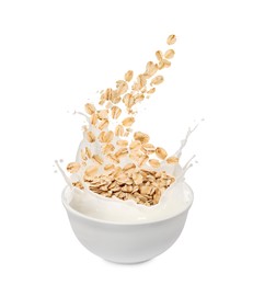 Image of Oats and milk splashing out from bowl on white background
