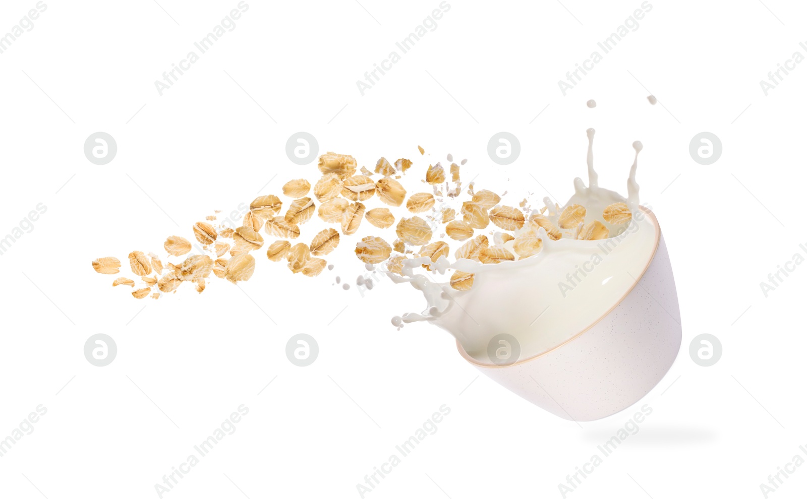 Oats and milk splashing out from bowl in air on white background Image of Oats and milk splashing out from bowl in air on white background