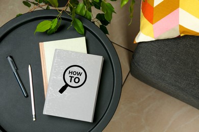 Image of How To book, pencil and pen on table indoors, top view. User guide