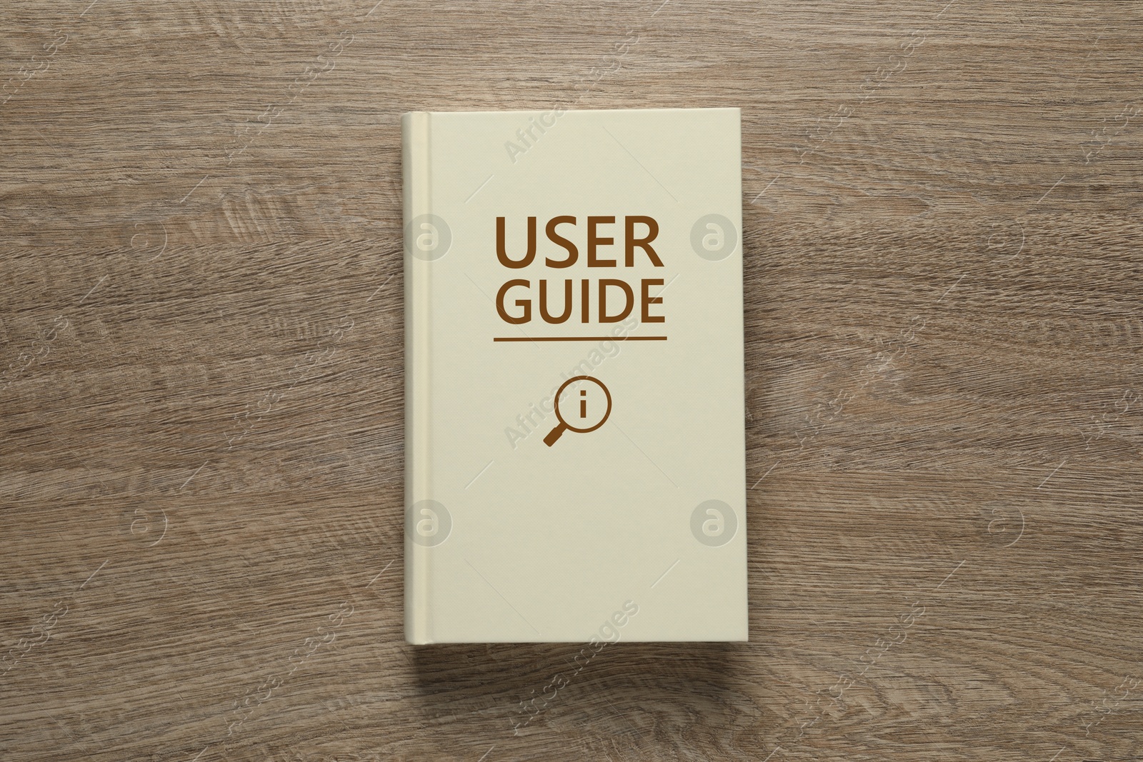 User Guide book on wooden table, top view Image of User Guide book on wooden table, top view
