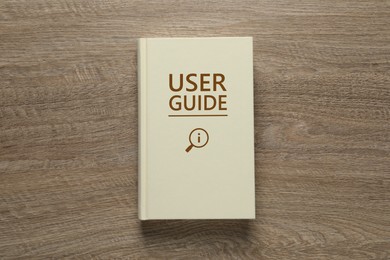 Image of User Guide book on wooden table, top view