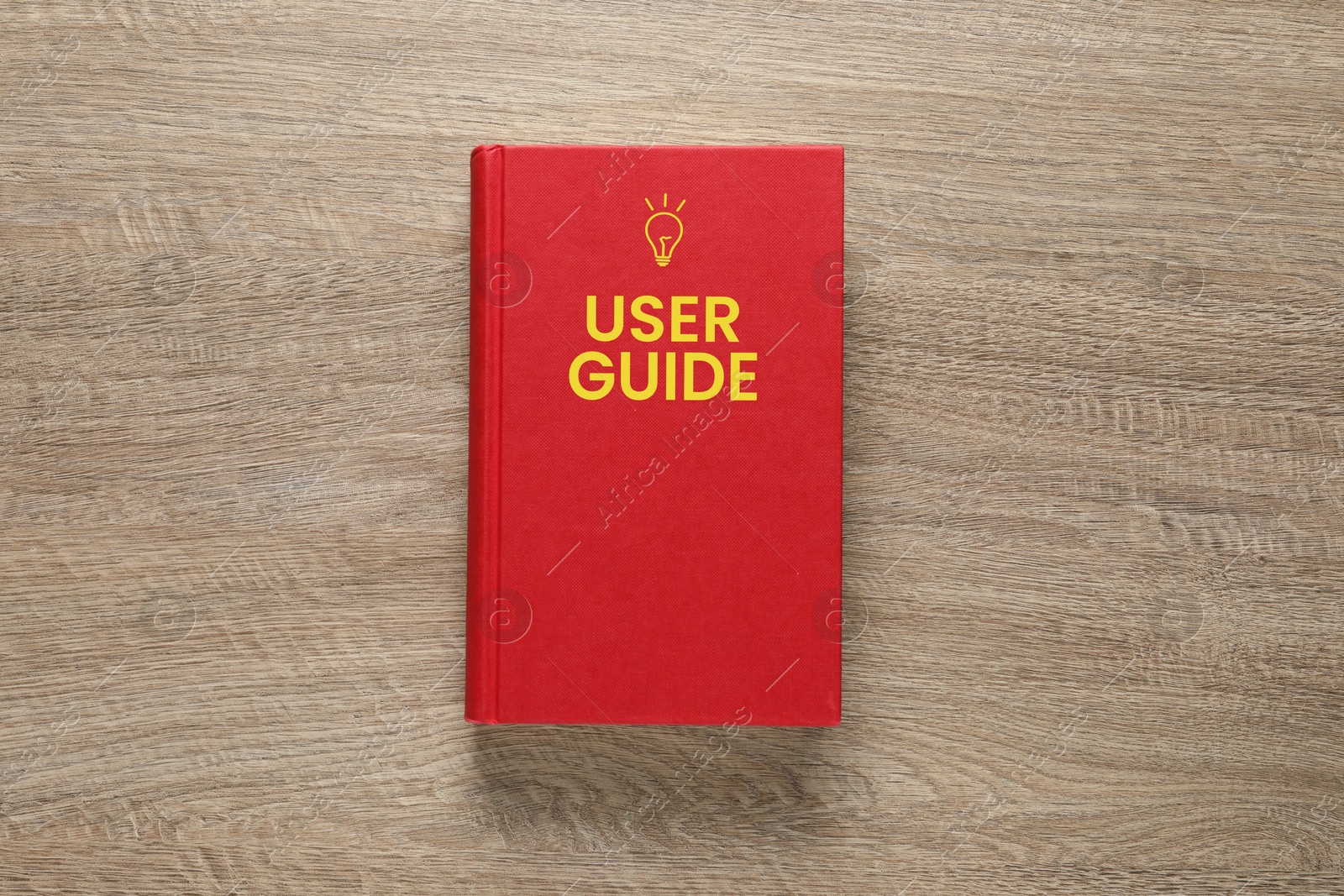 User Guide book on wooden table, top view Image of User Guide book on wooden table, top view