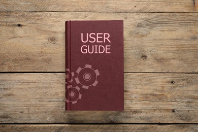 Image of User Guide book on wooden table, top view