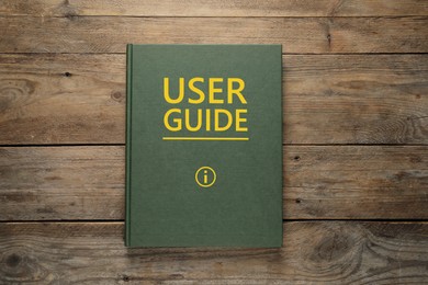 Image of User Guide book on wooden table, top view