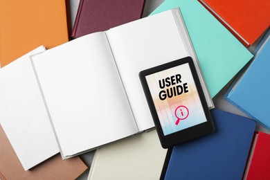 Image of User Guide document open in e-book device and many different books, to view