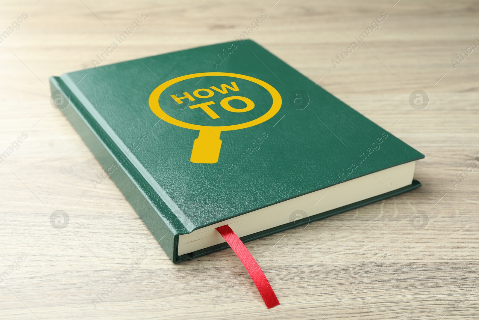 How To book on wooden table, closeup. User guide Image of How To book on wooden table, closeup. User guide