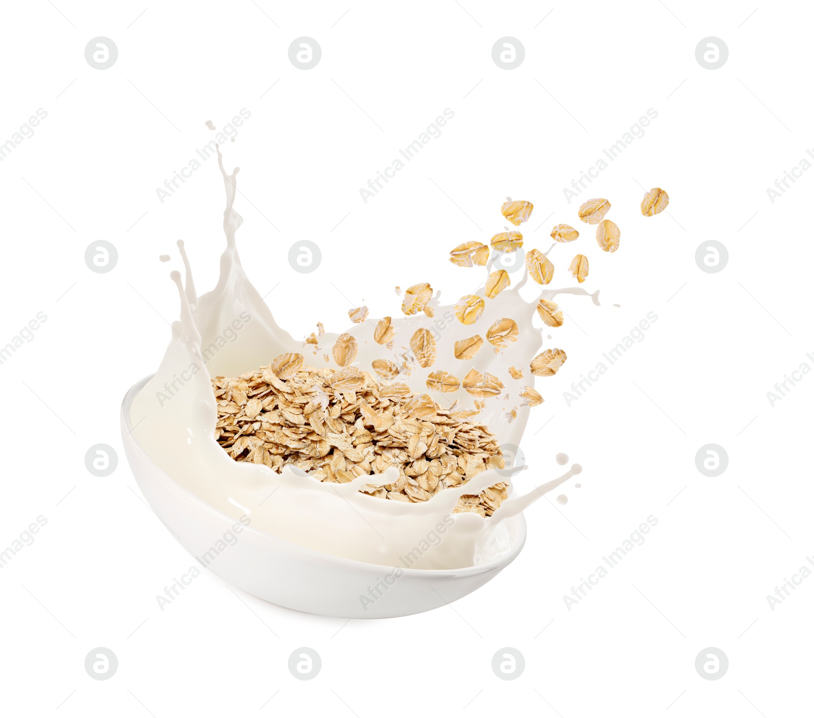 Oats and milk splashing out from bowl in air on white background Image of Oats and milk splashing out from bowl in air on white background