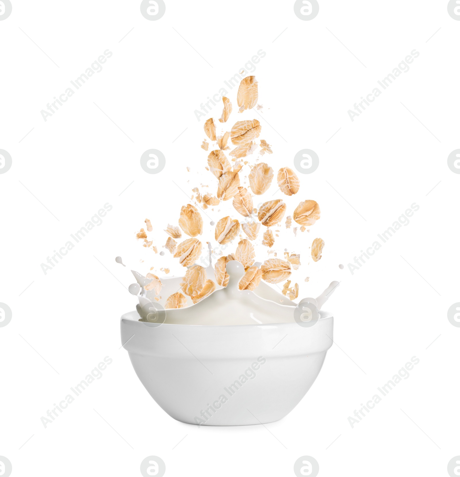 Oats and milk splashing out from bowl on white background Image of Oats and milk splashing out from bowl on white background