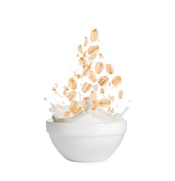 Image of Oats and milk splashing out from bowl on white background
