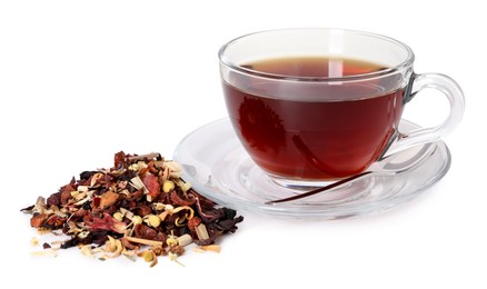 Photo of Delicious herbal tea in glass cup, spoon and dry leaves isolated on white