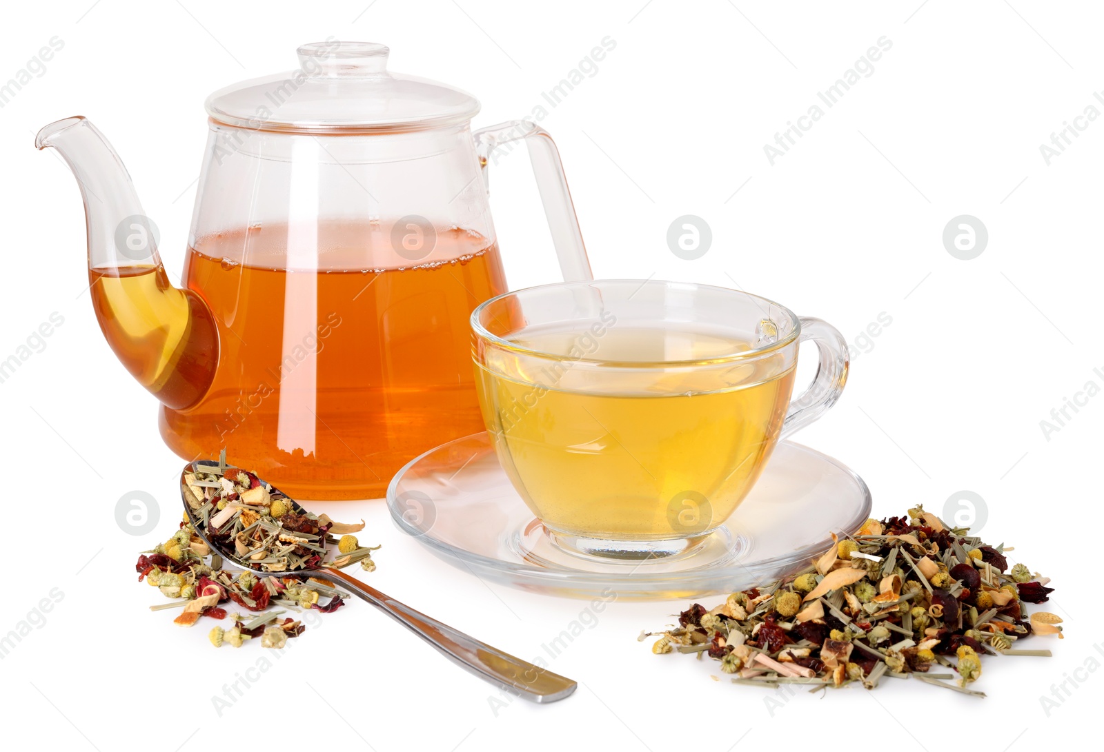 Delicious herbal tea in glass cup, teapot, spoon and dry leaves isolated on white Photo of Delicious herbal tea in glass cup, teapot, spoon and dry leaves isolated on white
