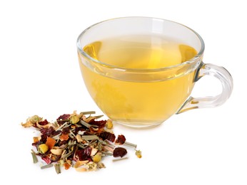 Photo of Delicious herbal tea in glass cup and dry leaves isolated on white