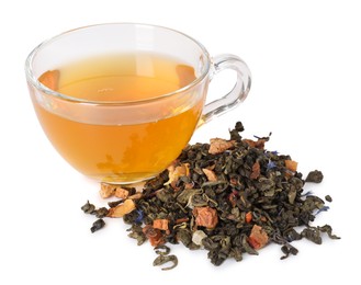 Photo of Delicious herbal tea in glass cup and dry leaves isolated on white