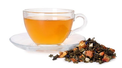 Photo of Delicious herbal tea in glass cup and dry leaves isolated on white
