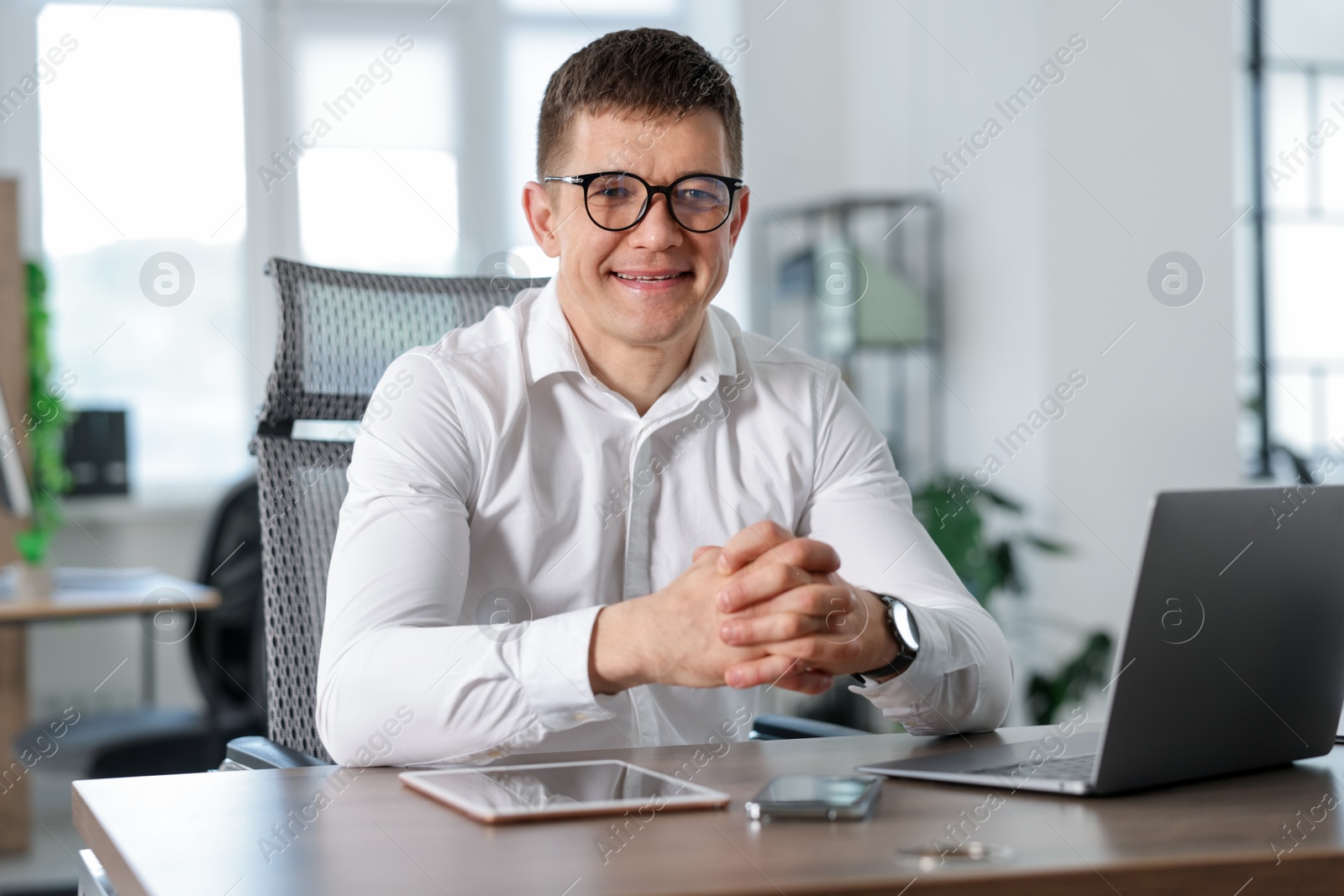 Portrait of handsome man at desk in office Photo of Portrait of handsome man at desk in office