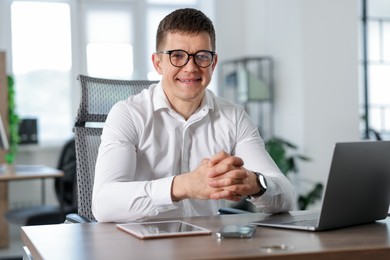 Photo of Portrait of handsome man at desk in office