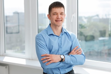 Photo of Portrait of handsome man near window indoors