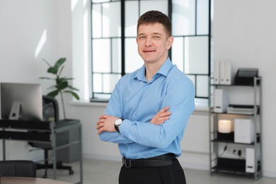 Photo of Portrait of handsome middle aged man in office