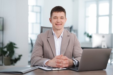 Photo of Portrait of handsome man at desk in office