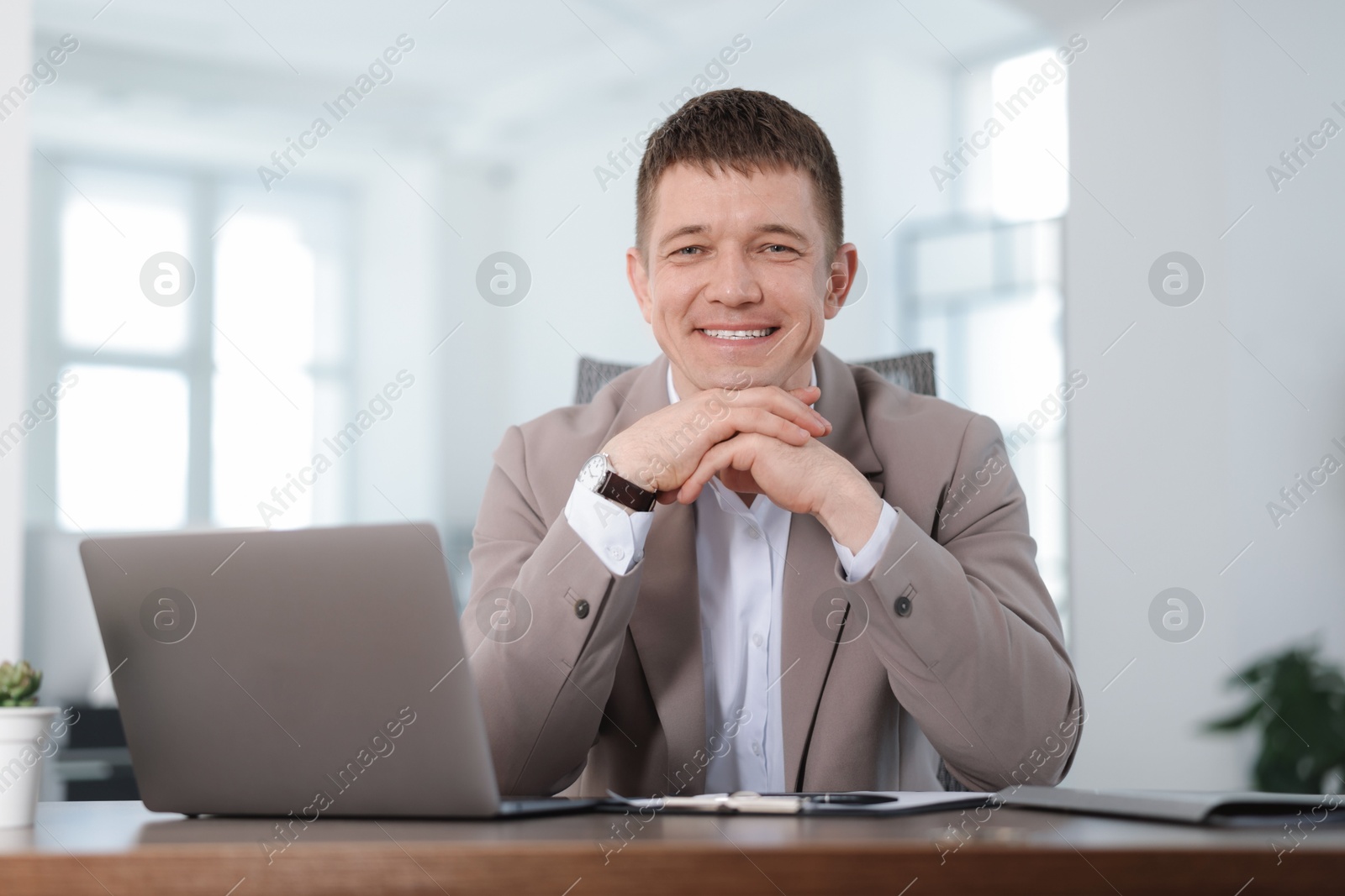 Photo of Portrait of handsome man at desk in office