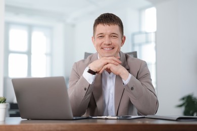 Photo of Portrait of handsome man at desk in office