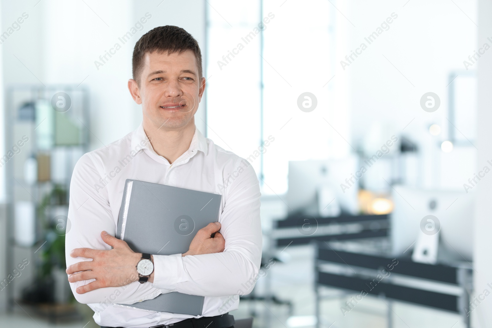 Portrait of handsome man with folder in office. Space for text Photo of Portrait of handsome man with folder in office. Space for text