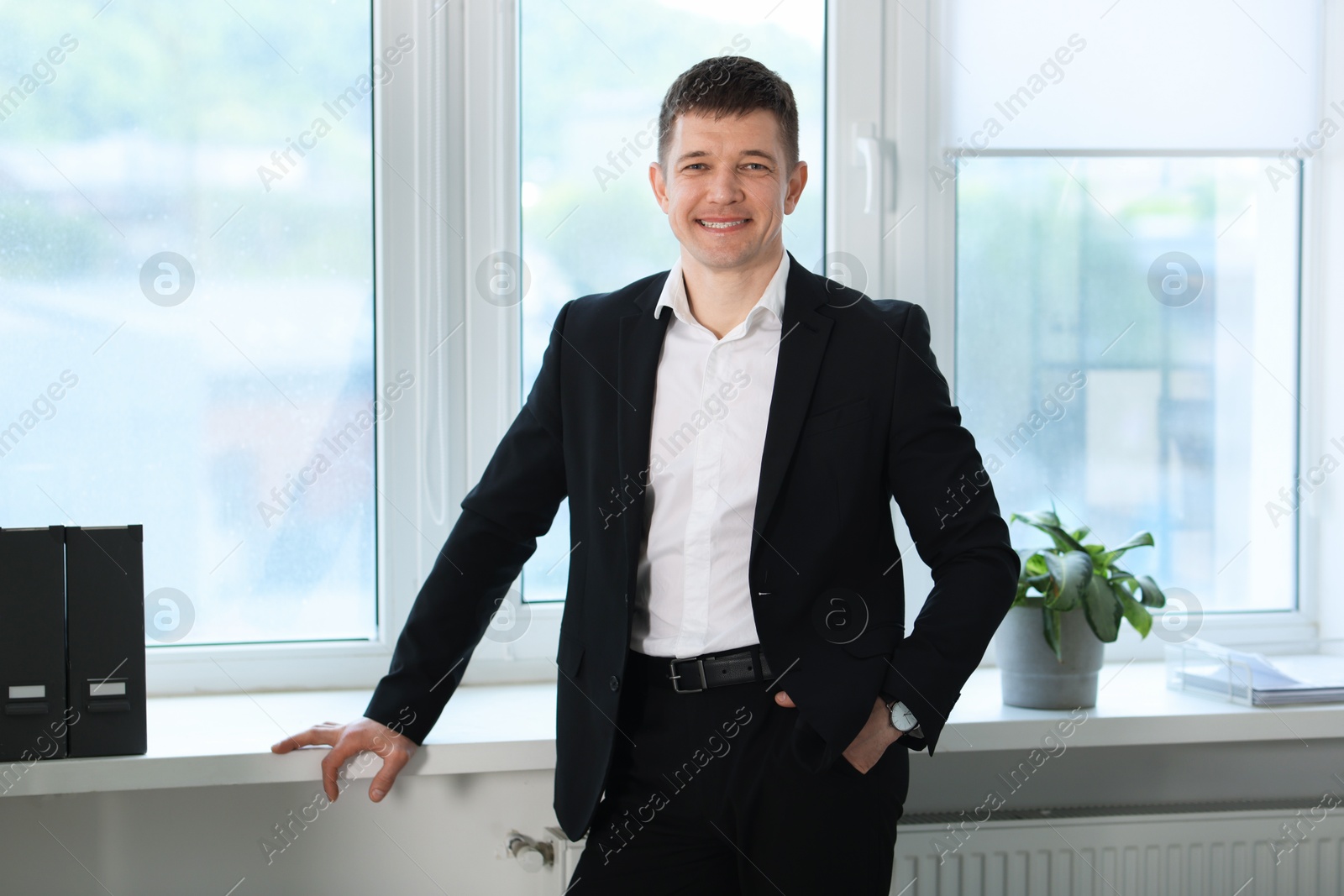 Portrait of handsome man near window indoors Photo of Portrait of handsome man near window indoors