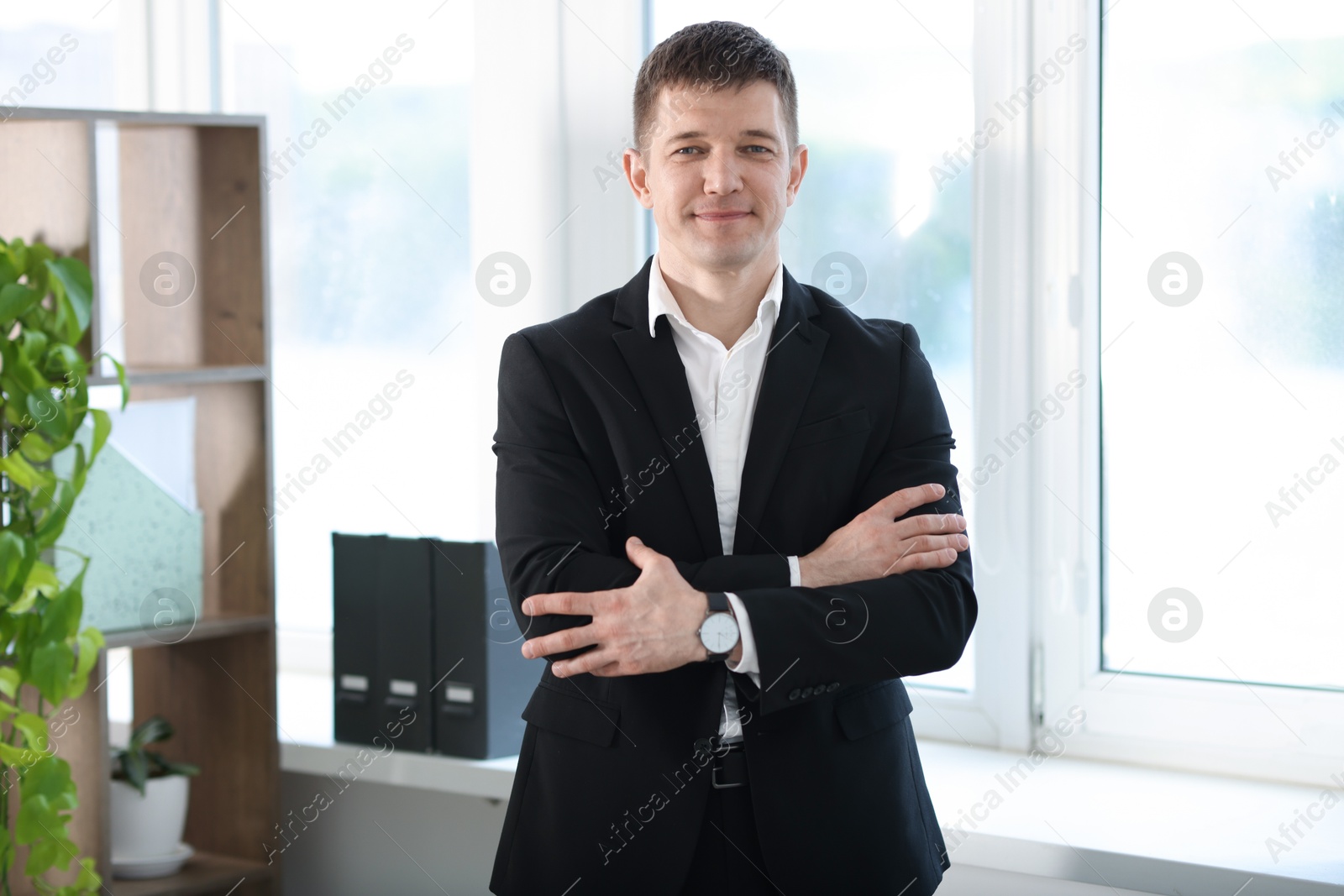 Portrait of handsome man near window indoors Photo of Portrait of handsome man near window indoors