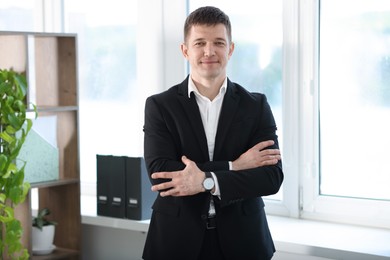 Photo of Portrait of handsome man near window indoors