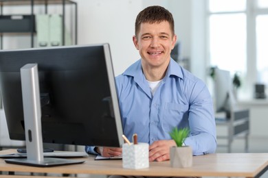 Photo of Handsome man working at desk in office