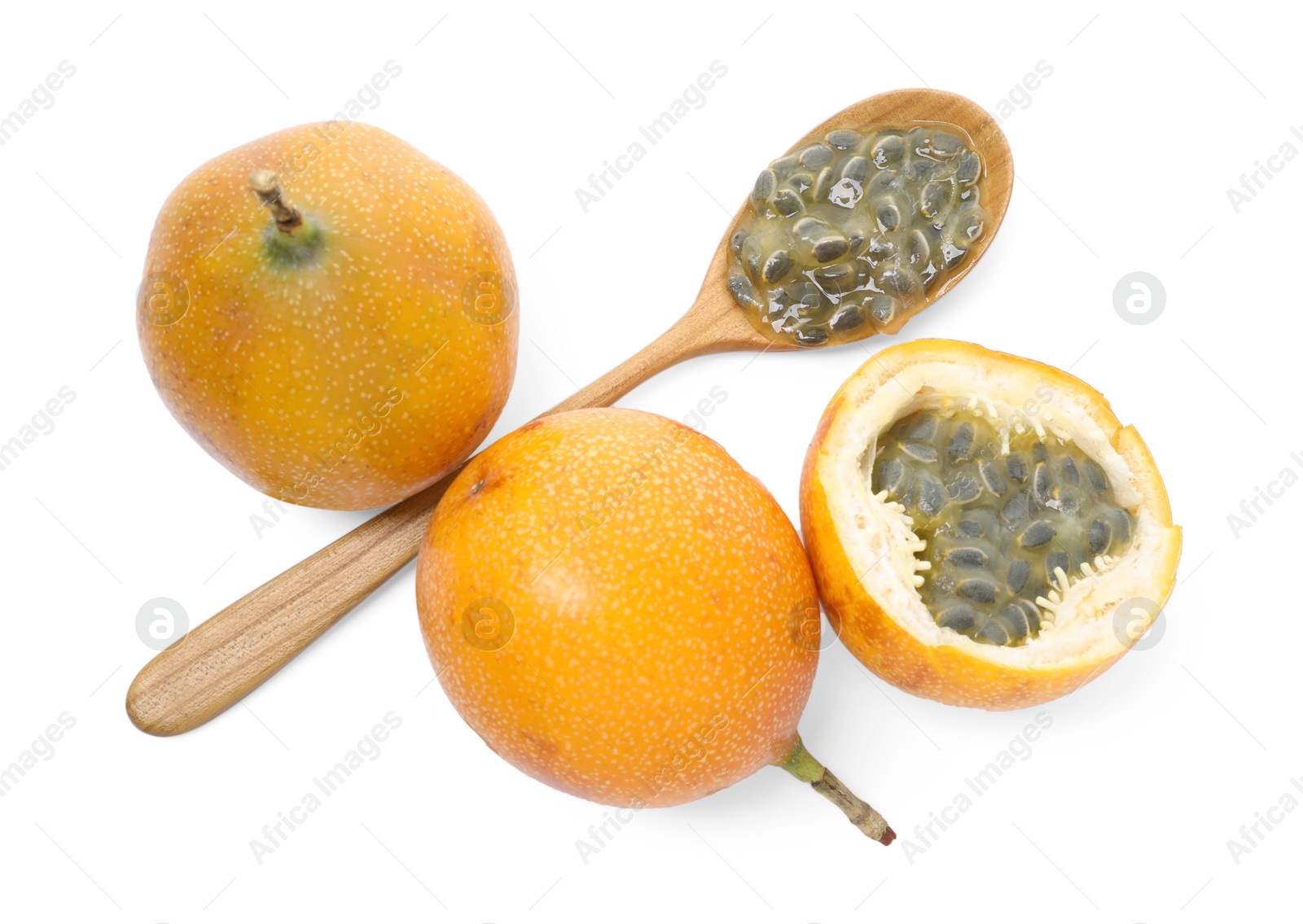 Ripe passion fruits, seeds, green leaves and spoon isolated on white, top view Photo of Ripe passion fruits, seeds, green leaves and spoon isolated on white, top view