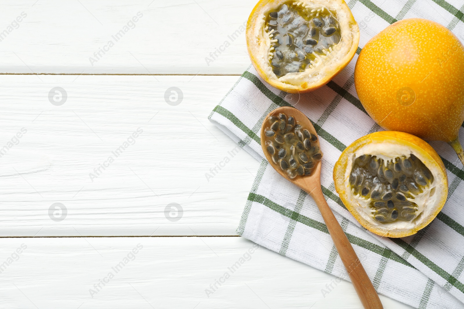 Ripe passion fruits and seeds on white wooden table, flat lay. Space for text Photo of Ripe passion fruits and seeds on white wooden table, flat lay. Space for text