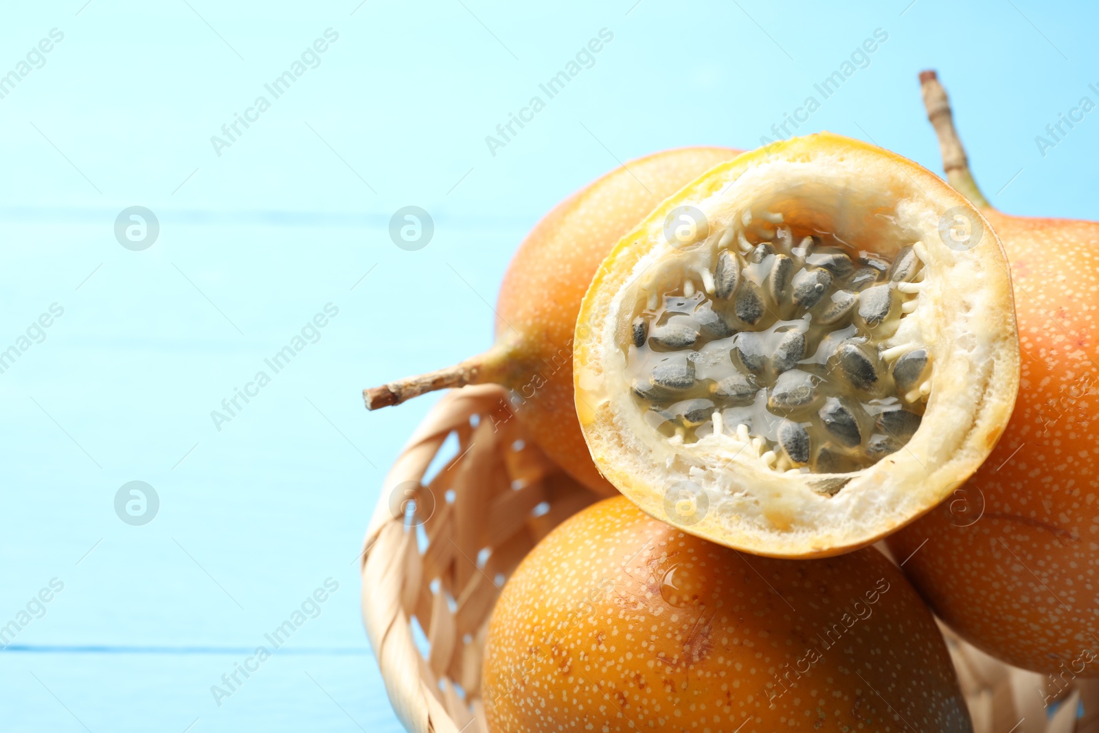 Ripe passion fruits on light blue table, closeup. Space for text Photo of Ripe passion fruits on light blue table, closeup. Space for text