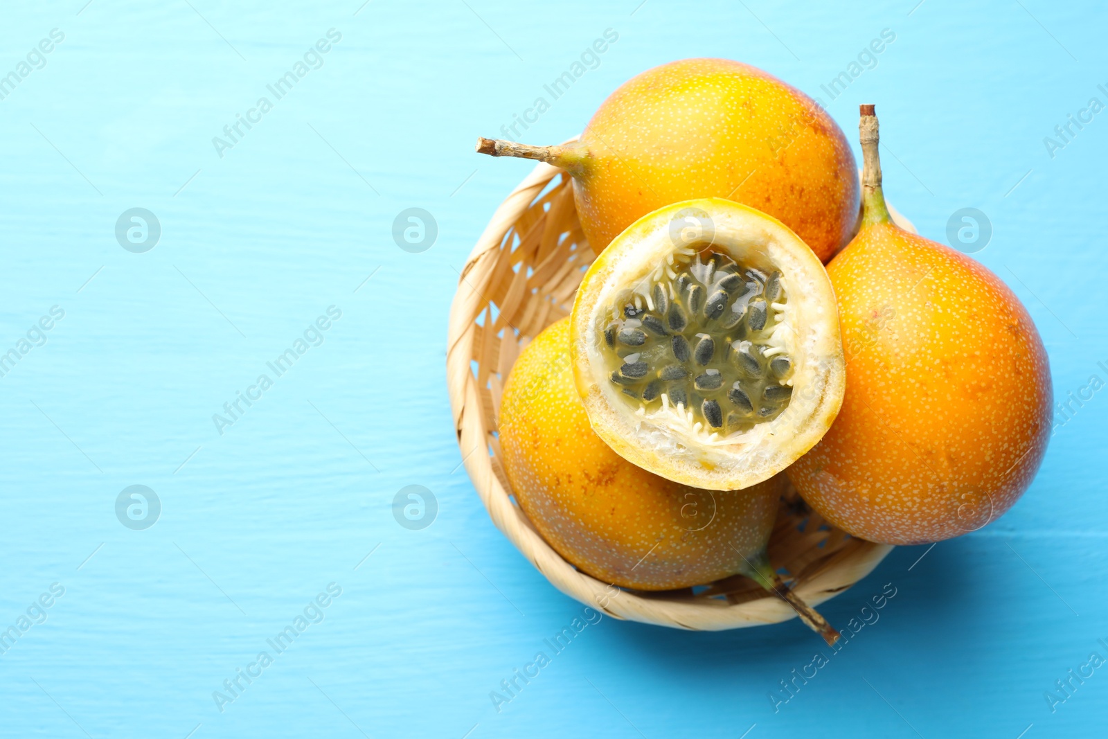 Ripe passion fruits on light blue wooden table, top view. Space for text Photo of Ripe passion fruits on light blue wooden table, top view. Space for text