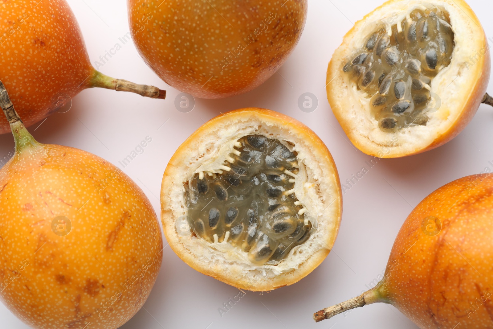 Ripe passion fruits on white background, flat lay Photo of Ripe passion fruits on white background, flat lay