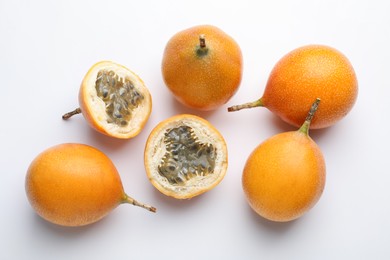 Photo of Ripe passion fruits on white background, flat lay