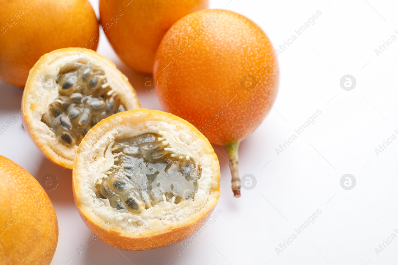 Ripe passion fruits on white background, closeup. Space for text Photo of Ripe passion fruits on white background, closeup. Space for text