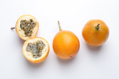 Photo of Ripe passion fruits on white background, flat lay