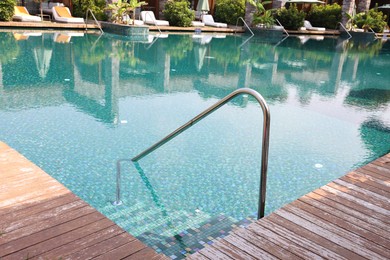 Photo of Outdoor swimming pool with steps and rail at resort