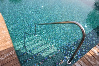 Photo of Outdoor swimming pool with steps and rail at resort