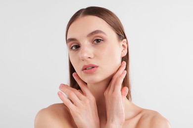 Photo of Portrait of attractive young woman on white background