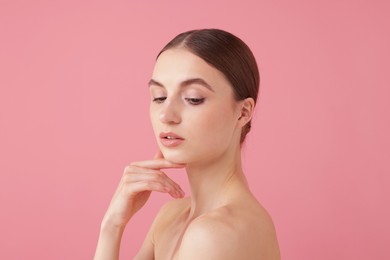 Photo of Portrait of beautiful young woman on pink background