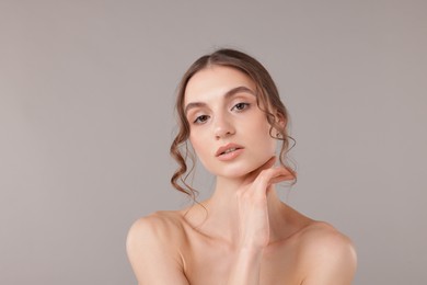 Photo of Portrait of attractive young woman on light grey background