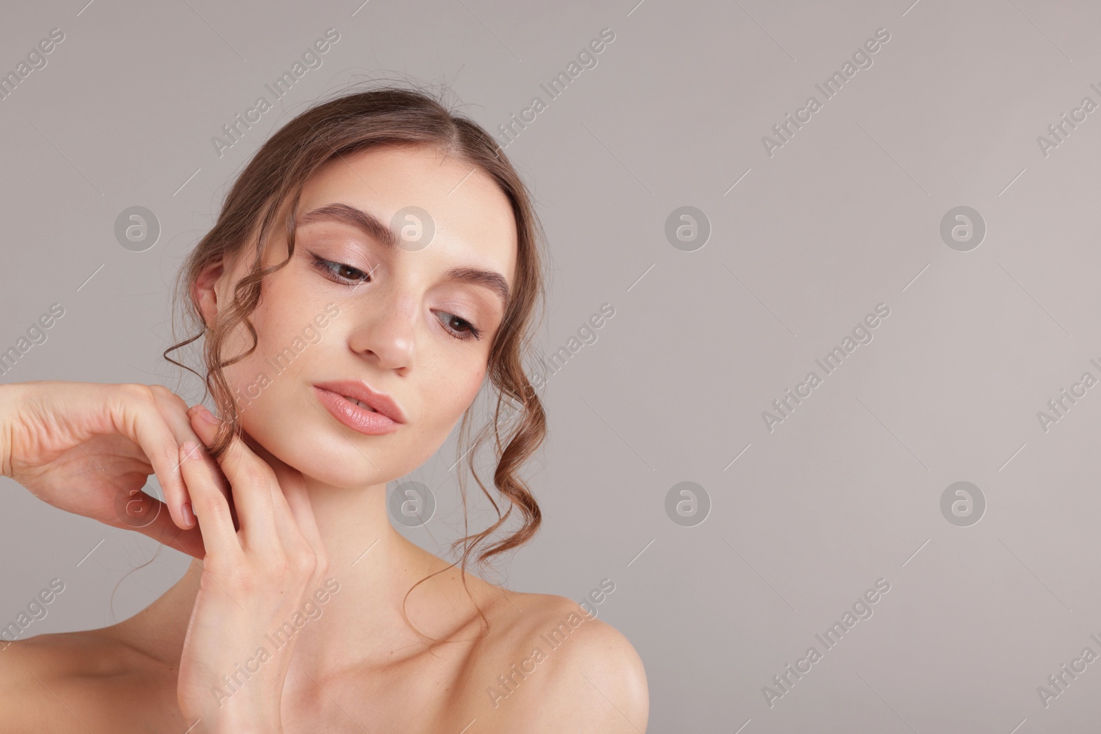 Portrait of attractive young woman on light grey background. Space for text Photo of Portrait of attractive young woman on light grey background. Space for text
