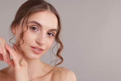 Photo of Portrait of attractive young woman on light grey background. Space for text