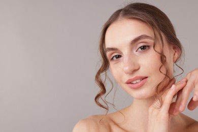 Photo of Portrait of attractive young woman on light grey background. Space for text