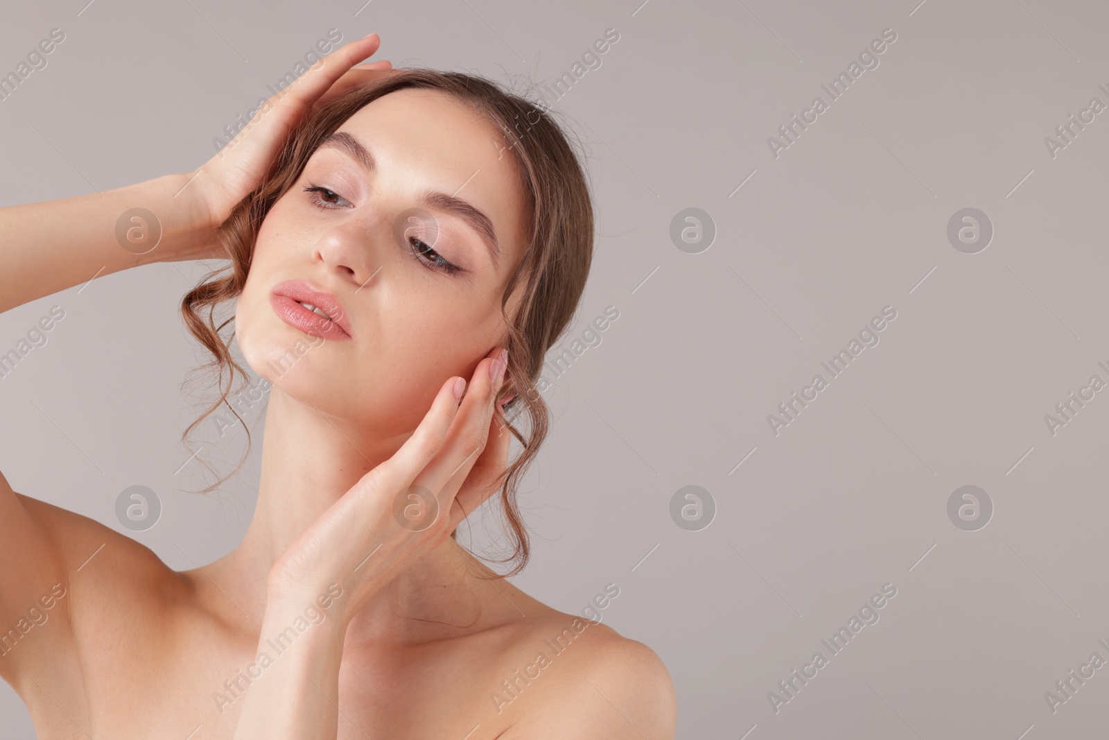 Portrait of attractive young woman on light grey background. Space for text Photo of Portrait of attractive young woman on light grey background. Space for text