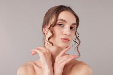 Photo of Portrait of attractive young woman on light grey background