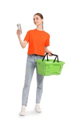 Photo of Woman with plastic shopping basket and smartphone on white background