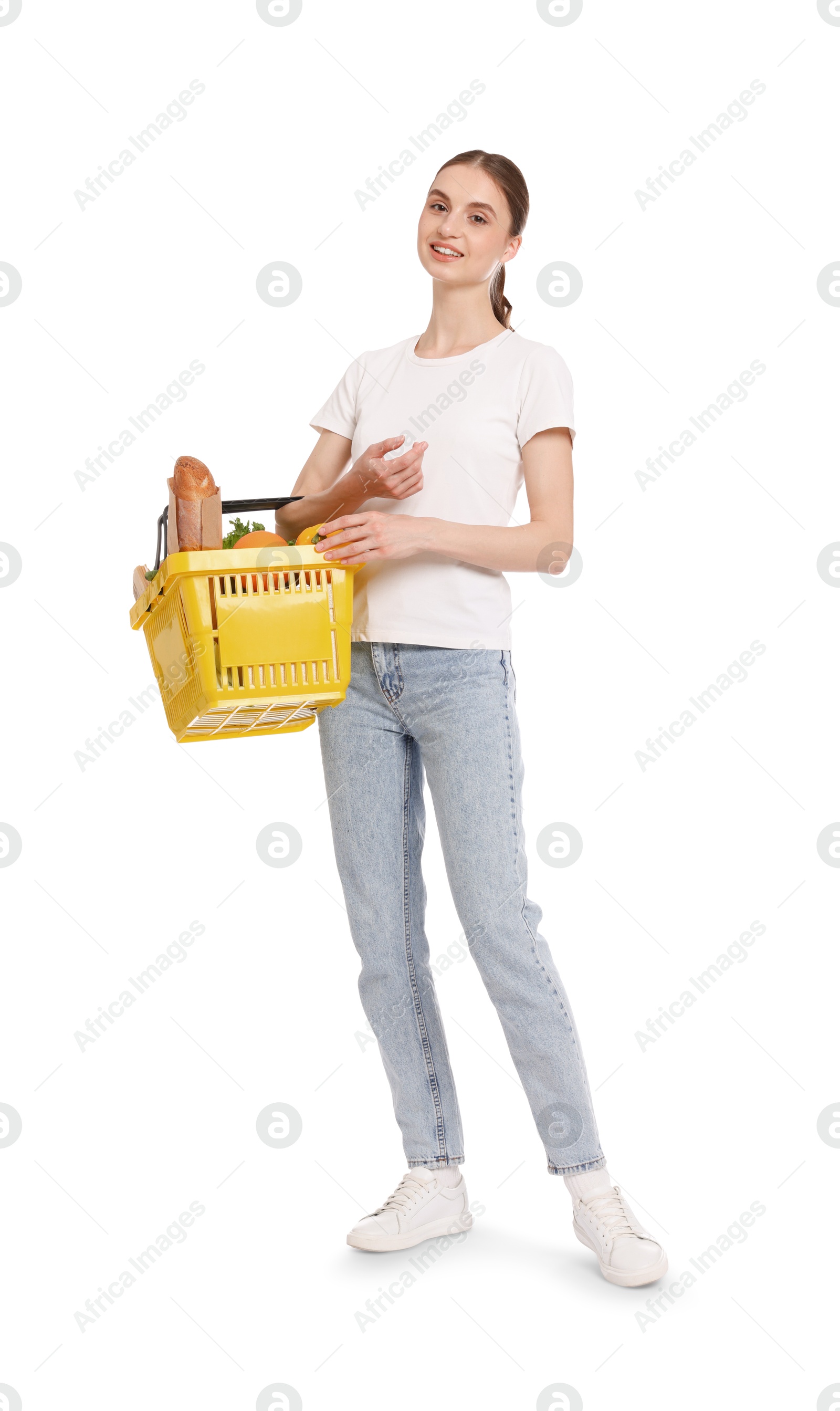 Woman with shopping basket full of products on white background Photo of Woman with shopping basket full of products on white background